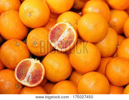 Ripe Oranges And An Orange Cut In The Stall Of Greengrocer