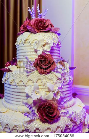 Wedding cake with roses Delicious white wedding cake decorated with pink cream roses