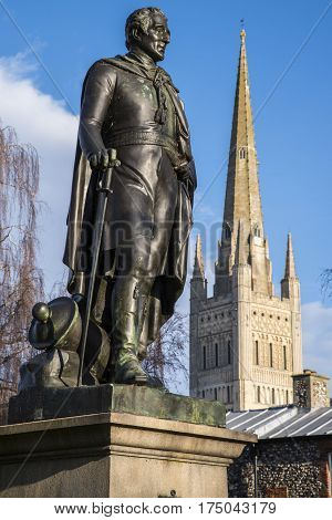 A statue of the Duke of Wellington with the beautiful Norwich Cathedral in the background in the historic city of Norwich UK.