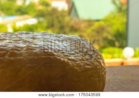head of traditional Adygei cheese handmade on wooden Board