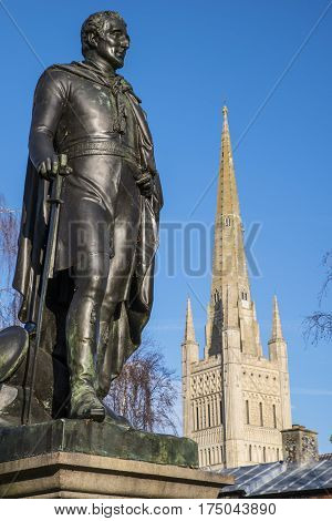 A statue of the Duke of Wellington with the beautiful Norwich Cathedral in the background in the historic city of Norwich UK.