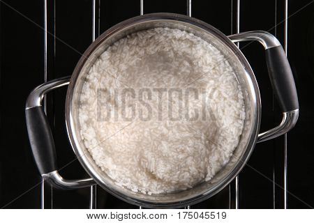 Rice in metal pan on hotplate