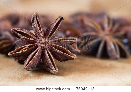 A retro looking star anise background in brown tones.