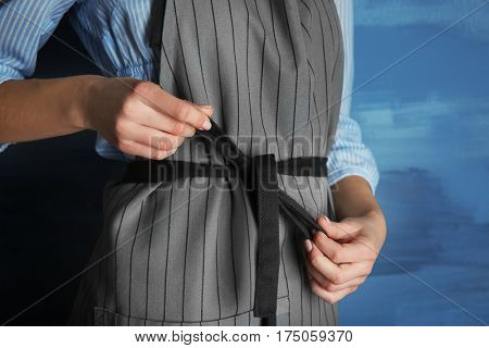 Woman  tying up her apron around the waist