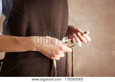 Woman  tying up her apron around the waist