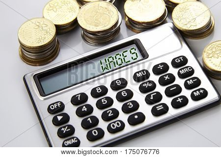 few stacks of coins and calculator with text on screen statistics