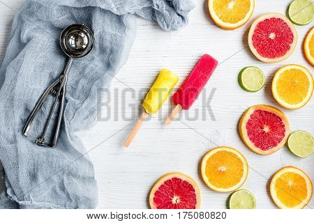 Homemade orange icecream with fresh fruits on stone table background top view