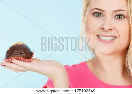 Woman Holding Chocolate Cupcake About To Bite