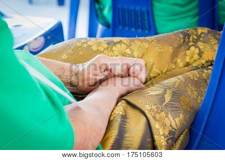 closeup hand of old asian woman suffering from leprosy amputated hand