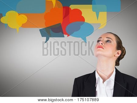 Businesswoman with multicolored speech bubble against grey background