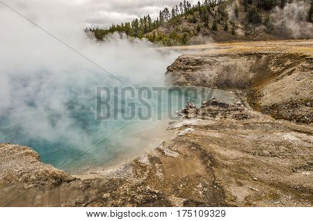 Close-up of Excelsior Geyser in Yellowstone National Park as the wind shifts and blows some of the steam away