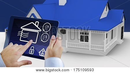 Digital generated image of hands using digital tablet with home security icons