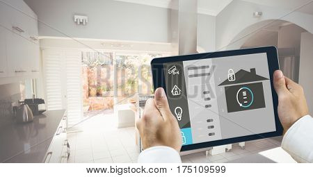 Digital composite image of hands holding digital tablet with home security icons