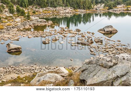 Calm lake with rocks and nice reflections along the Beartooth Highway