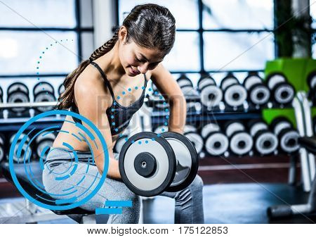 Digital composition of fit woman performing bicep curl exercise in gym against digital fitness interface