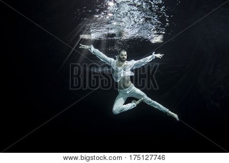 A Young Male Ballet Dancer Posing Underwater