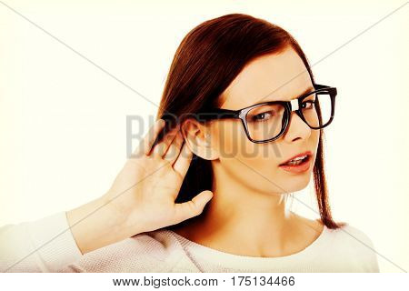 Shocked young woman overhearing a conversation