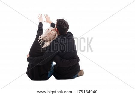 Rear View Of Young Couple Sitting Down