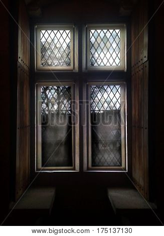 Old window with stained glass and wooden shutters