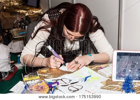 Moscow, Russia - November, 2016: Girl using 3D printing pen