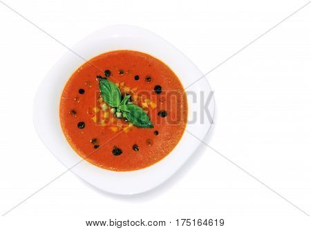 Gaspacho cold summer soup in porcelain plate isolated on white background.