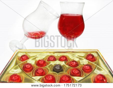 red wine in glass goblets and chocolate sweets