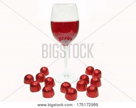 red wine in glass goblet and chocolate sweets