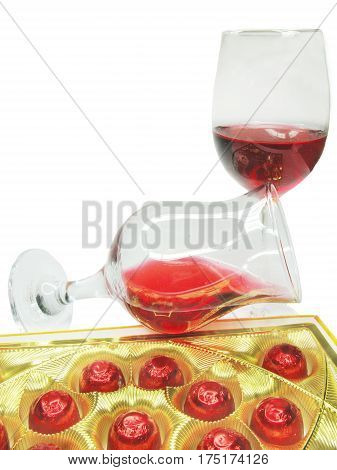 red wine in glass goblets and chocolate sweets