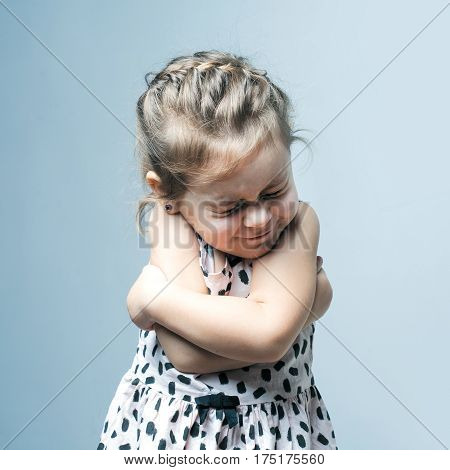 Portrait of a little girl. She is crying