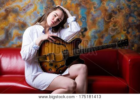Podolsk, Russia - February 21, 2017: Young brunette girl with a vintage electric guitar Gibson es-345 1969 model year