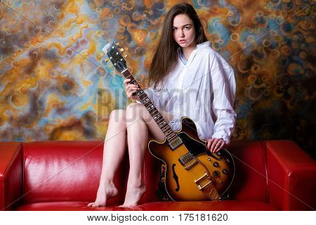 Podolsk, Russia - February 21, 2017: Young brunette girl with a vintage electric guitar Gibson es-345 1969 model year