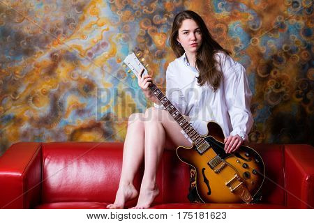 Podolsk, Russia - February 21, 2017: Young brunette girl with a vintage electric guitar Gibson es-345 1969 model year