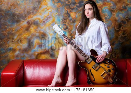 Podolsk, Russia - February 21, 2017: Young brunette girl with a vintage electric guitar Gibson es-345 1969 model year