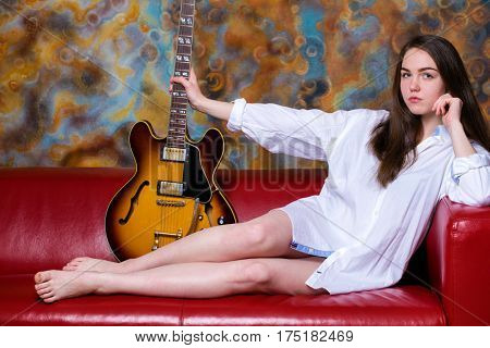 Podolsk, Russia - February 21, 2017: Young brunette girl with a vintage electric guitar Gibson es-345 1969 model year