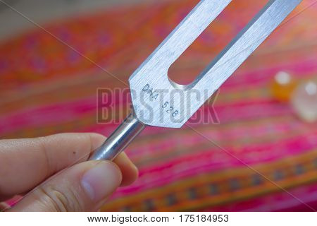 tuning fork and crystal on table .