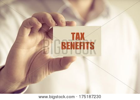 Businessman Holding Tax Benefits Message Card