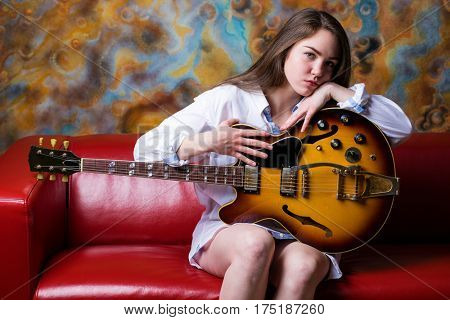 Podolsk, Russia - February 21, 2017: Young brunette girl with a vintage electric guitar Gibson es-345 1969 model year