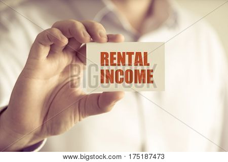 Businessman Holding Rental Income Message Card