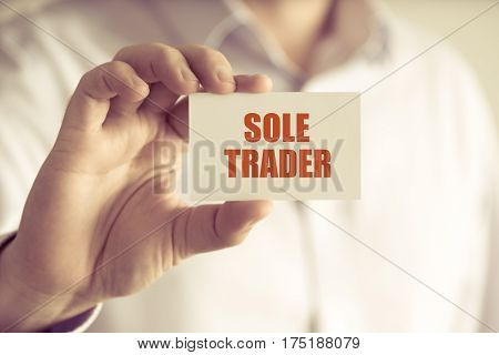 Businessman Holding Sole Trader Message Card