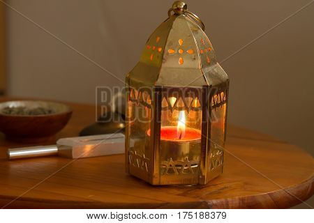 pink candle on a white table .