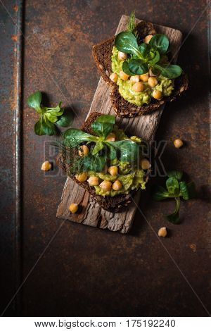 Vegetarian sandwiches on a wooden stand vertical