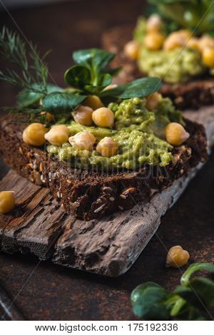 Vegetarian sandwiches on a wooden support close up vertical