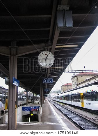 Schaffhausen Switzerland - August 9 2007: Train station with moving Thurbo train and people walking