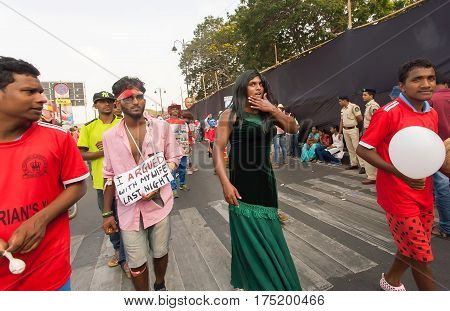PANAJI, INDIA - FEB 25, 2017: Jealous travesty wife and her husband walking in parade of actors during the traditional carnival in Goa on February 25, 2017. Carnaval is celebrated in Goa since 18th century