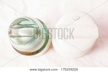 Old glass insulators for high voltage in studio on white background.