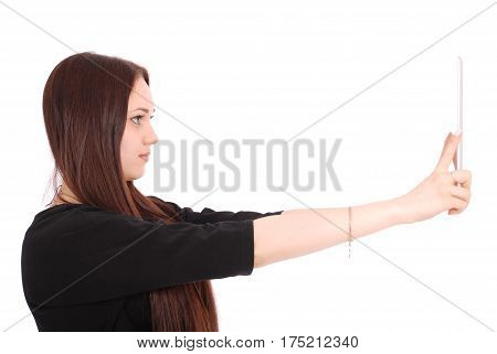 Girl looking at tablet pc standing sideways isolated on white