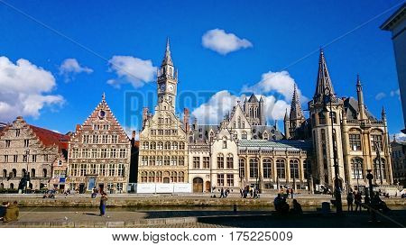 Ghent medieval city,  View of Graslei, Korenlei Streets, Korenmarkt, Post Office, Clock Tower over Leie river. Ghent, Belgium.