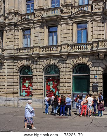 Zurich, Switzerland - 14 May, 2015: a group of people at the Credit Suisse building on Paradeplatz square. Credit Suisse Group is a leading global financial services company headquartered in Zurich.