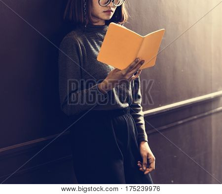 Girl with Glasses Standing Reading Book
