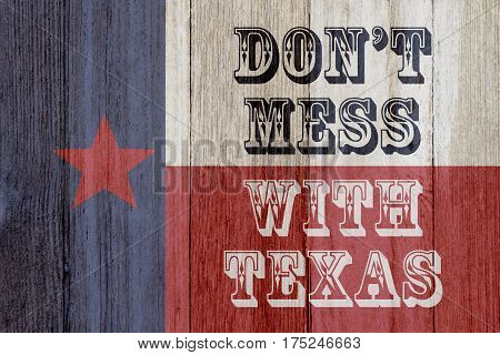 A rustic old Texas message Texas flag on weathered wood background with text Don't mess with Texas 3D Illustration